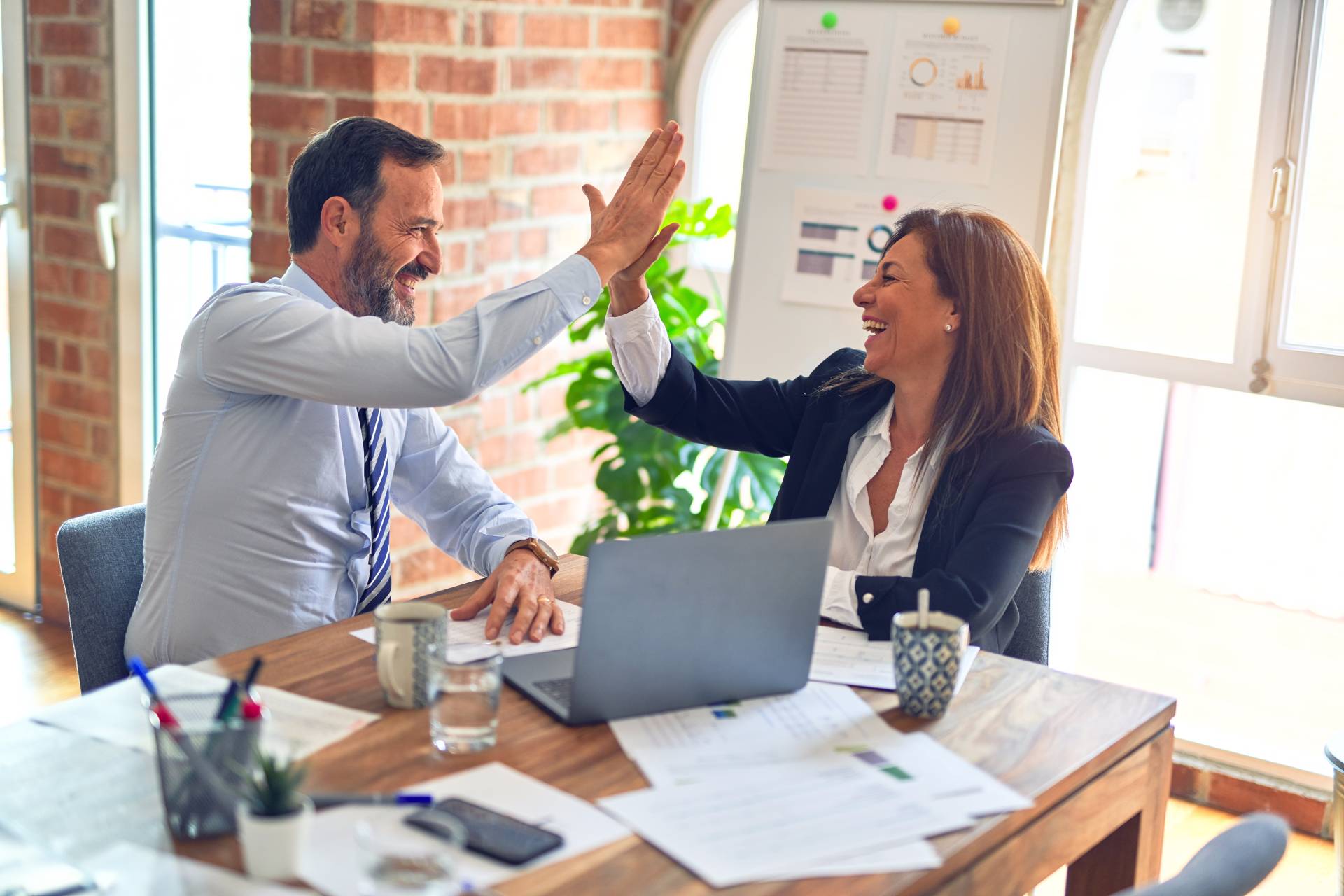 Co-workers collaborating and celebrating their stalled growth strategy